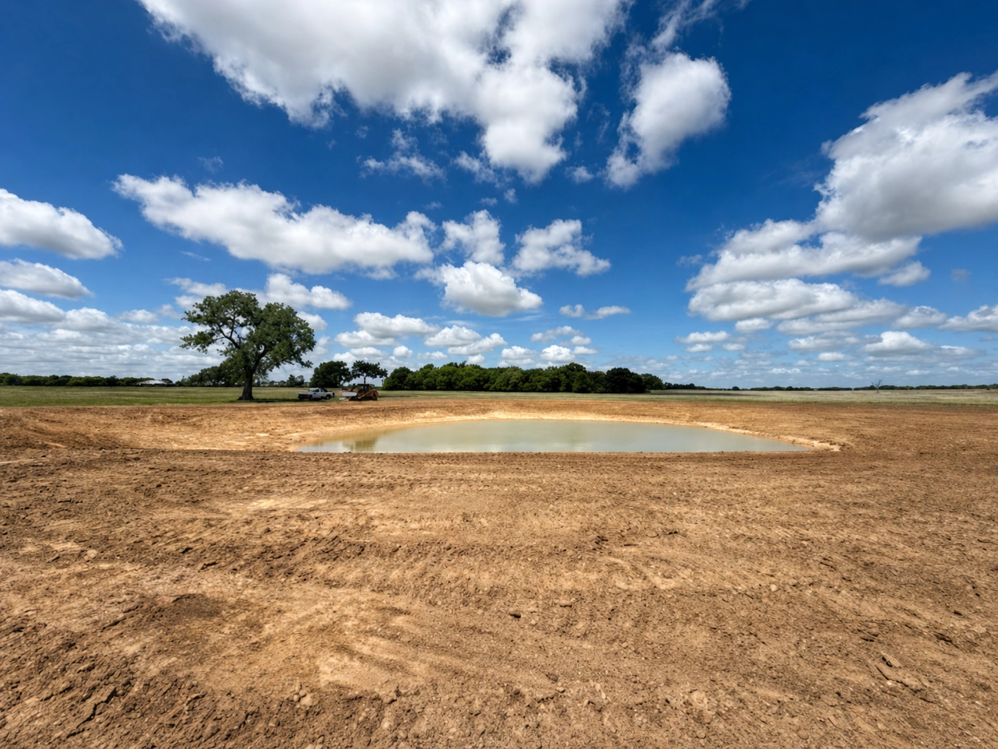 Excavating and shaping a clay-lined ranch stock tank and dam near Dublin, Texas